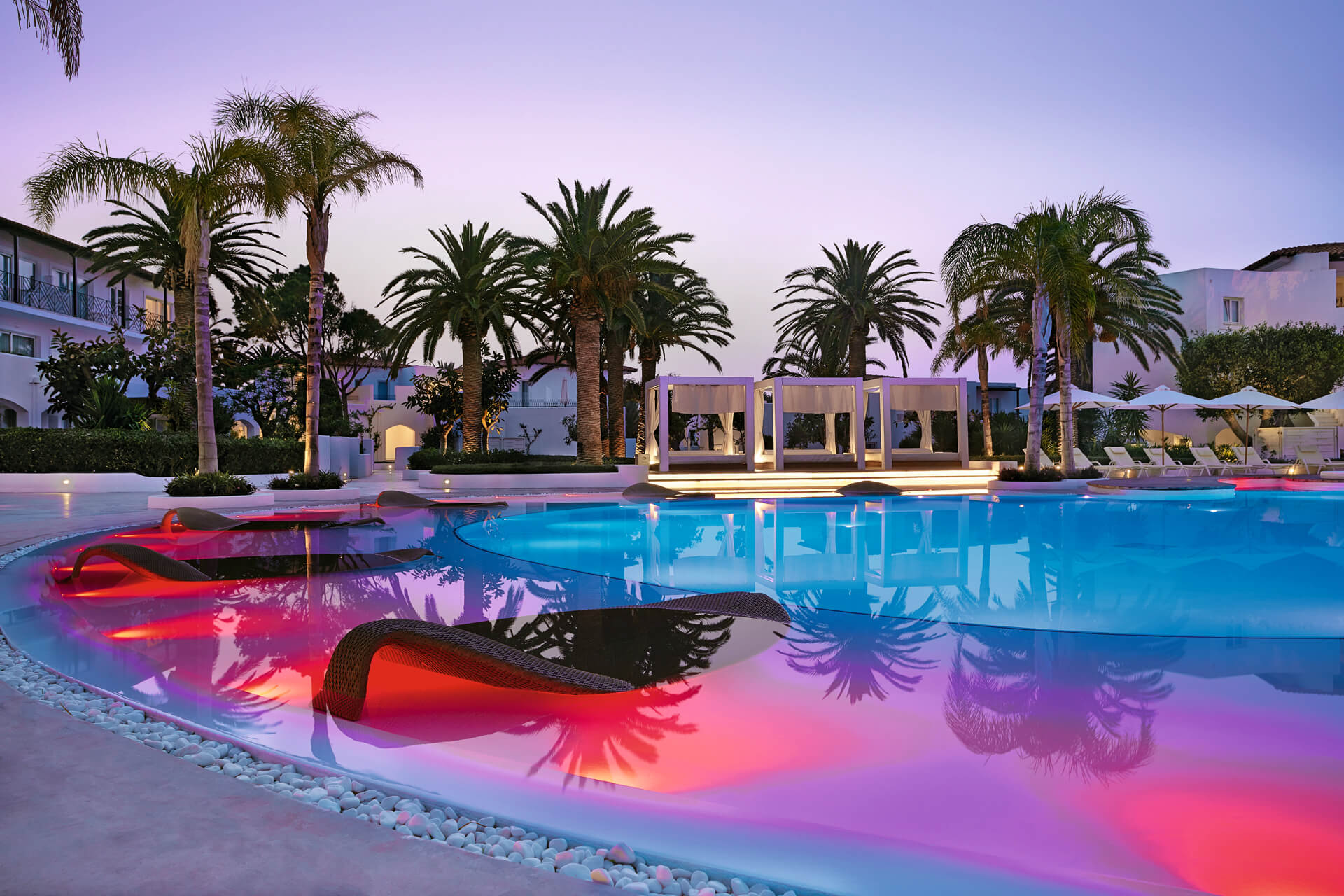 Unique-illuminated-pool-with-leaf-sun-beds